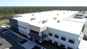 White TPO roof and DaVinci Shakes on a warehouse in Wilmington, NC.