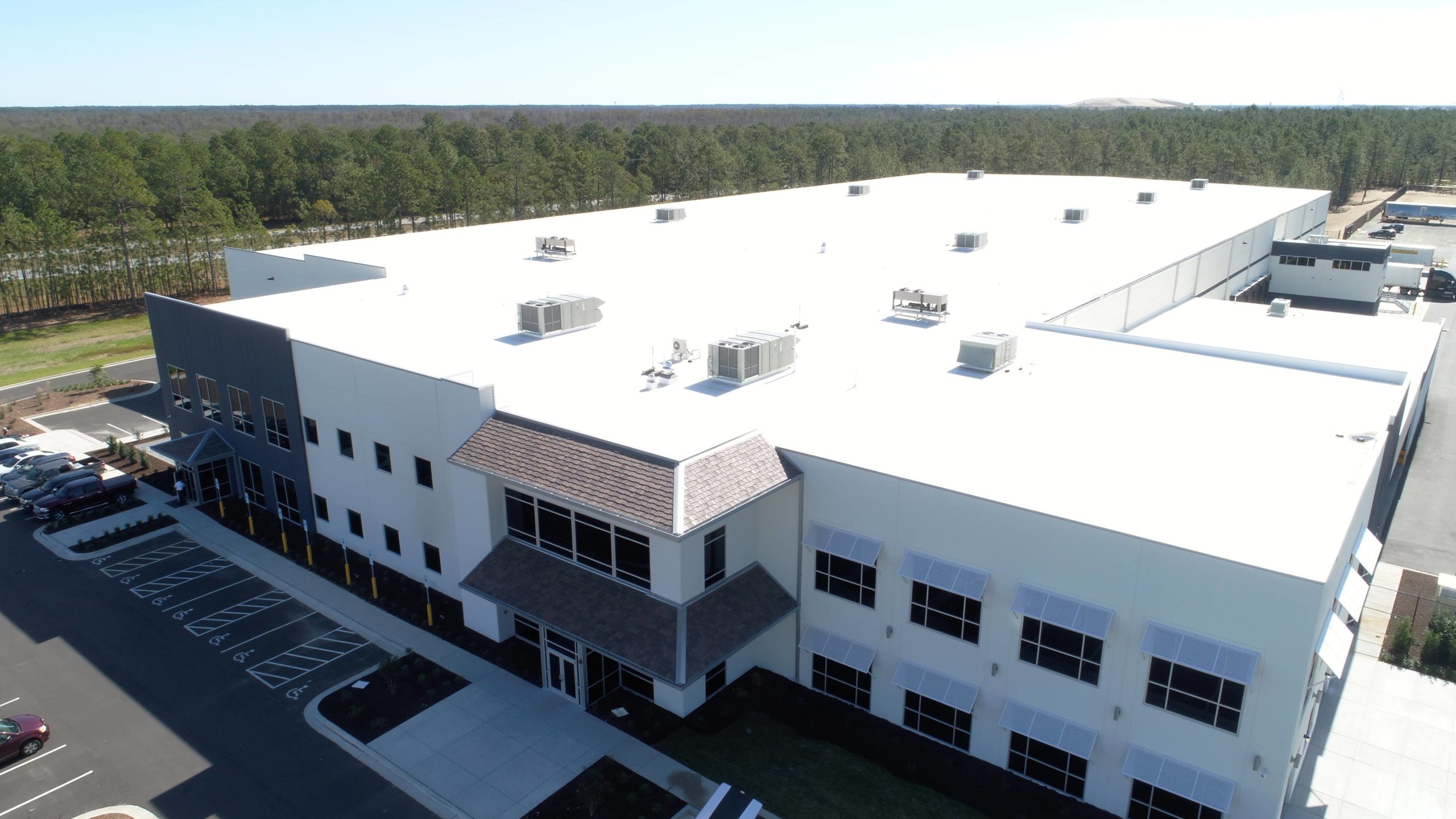 White TPO roof and DaVinci Shakes on a warehouse in Wilmington, NC.