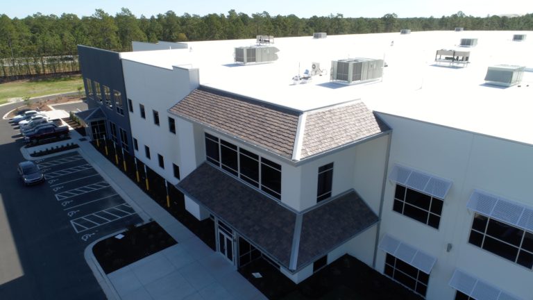 White TPO roof and DaVinci Shakes on a warehouse in Wilmington, NC.