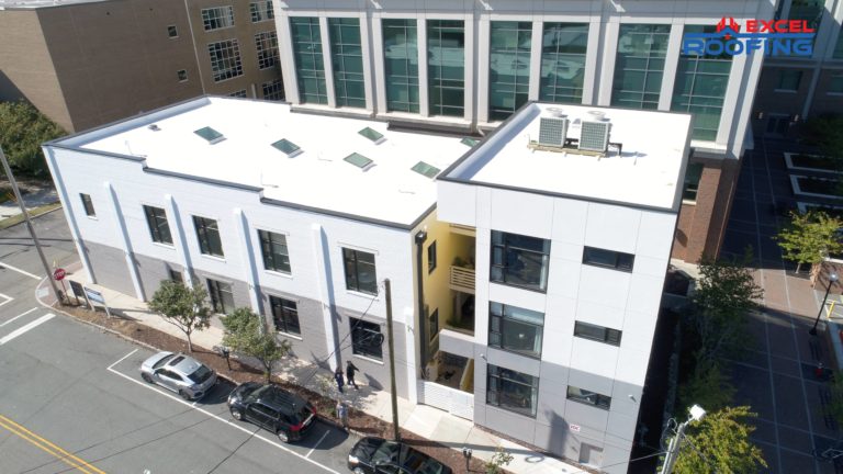 Aerial view of white TPO roof replacement on a commercial building in Wilmington, NC.