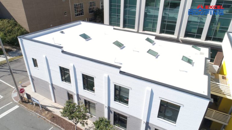 Aerial view of white TPO roof replacement on an office building in Wilmington, NC.