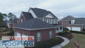 Designer shingle roof with metal accents on a house in Wilmington, NC.