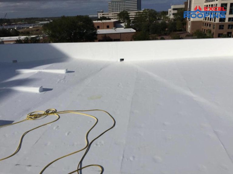 White TPO roofing membrane replacement on an office building in Wilmington, NC.