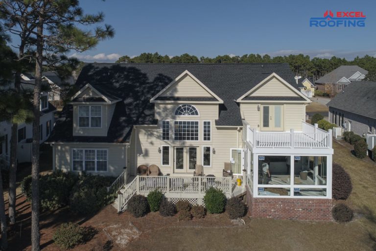 Two-story house with black architectural shingle roof in Wilmington, NC.
