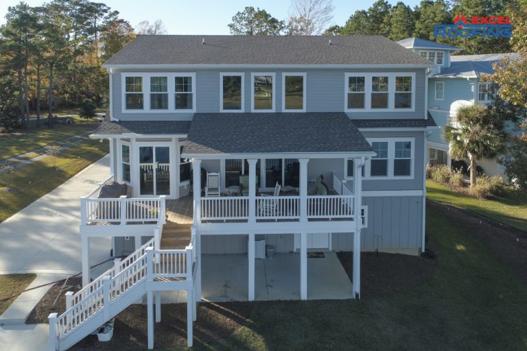 Two-story house with new shingle roof in Wilmington, NC.