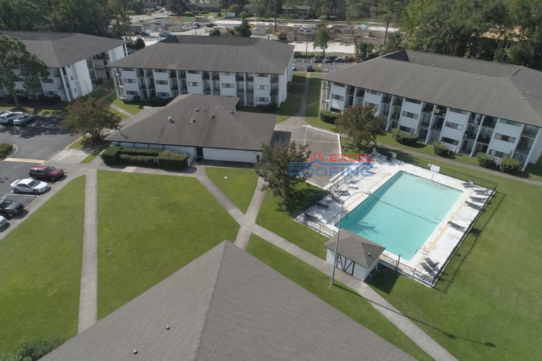 Aerial view of multiple apartment buildings with commercial shingle roofs replaced in Wilmington, NC.