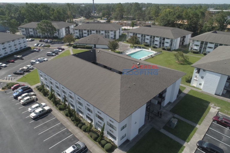 Aerial view of multiple apartment buildings with commercial shingle roofs replaced in Wilmington, NC.