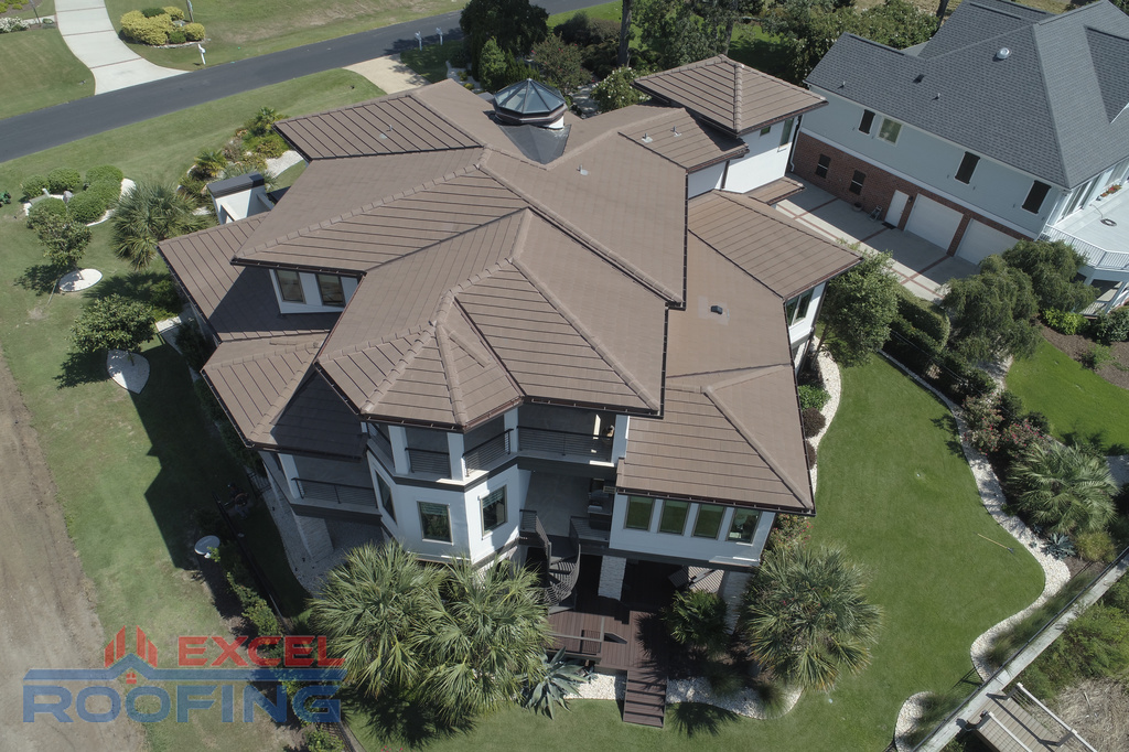 Concrete slate tile roof installed by Excel Roofing Company in St. James, Southport, NC, featuring weather-resistant durability and sophisticated design.