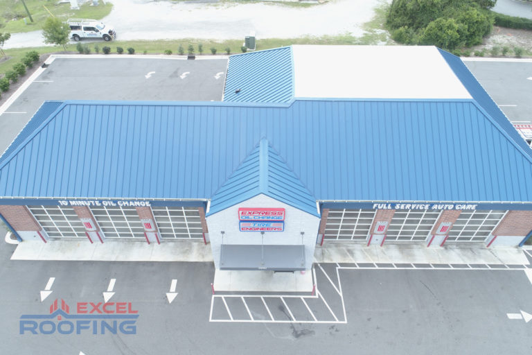 Commercial building in Wilmington, NC, with a metal roof and flat TPO roof installed by Excel Roofing Company.
