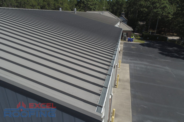 Commercial metal roof installed by Excel Roofing Company on the fire station in St. James, Southport, NC, showcasing weather-resistant materials and modern design.