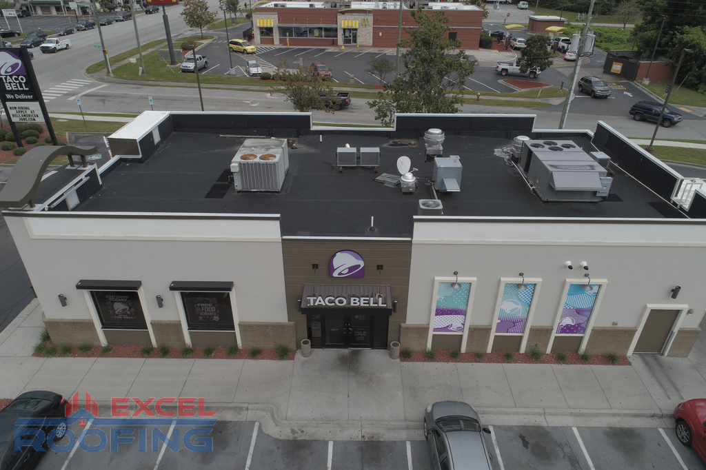 Black EPDM roof membrane replacement on a Taco Bell in Fayetteville, NC, by Excel Roofing Company, ensuring weather-resistant durability.