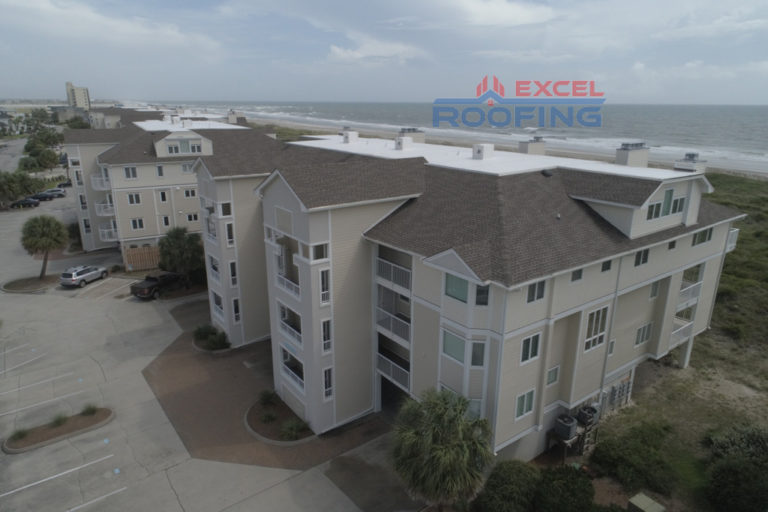 Luxury condos in Wrightsville Beach, NC, with new shingle and TPO roofs installed by Excel Roofing Company.