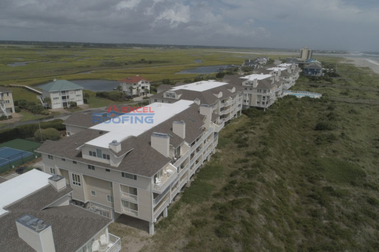 Luxury condos in Wrightsville Beach, NC, with new shingle and TPO roofs installed by Excel Roofing Company.