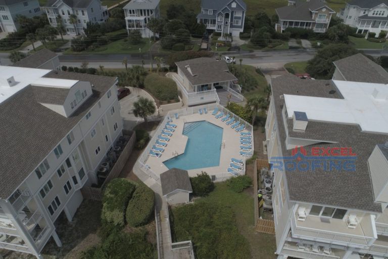 Luxury condo buildings in Wrightsville Beach, NC, with new shingle and TPO roofs installed by Excel Roofing Company.