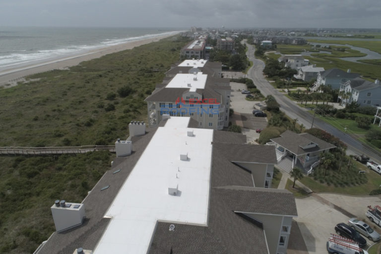 Luxury condos in Wrightsville Beach, NC, with new shingle and TPO roofs installed by Excel Roofing Company.