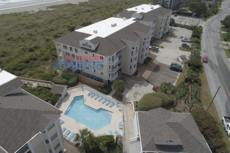 Luxury condo buildings in Wrightsville Beach, NC, with new shingle and TPO roofs installed by Excel Roofing Company.