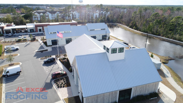 Aerial view of a metal roof installed by Excel Roofing over a shopping center in Wilmington, NC, featuring durable materials and modern design.