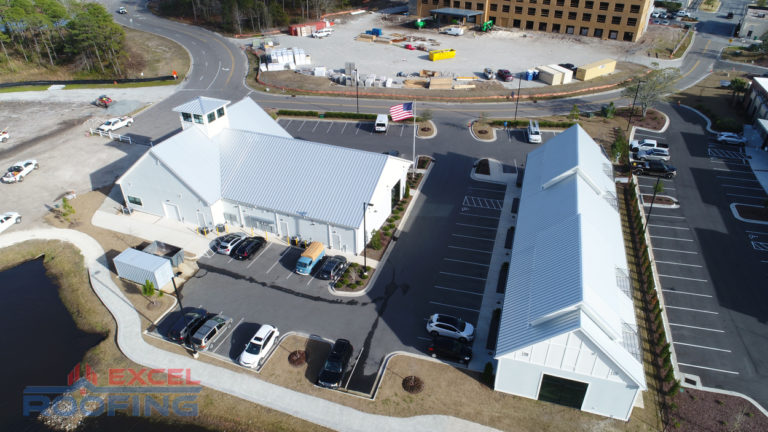 Standing seam metal roof installed by Excel Roofing over a shopping center in Wilmington, NC, highlighting weather resistance and modern design.