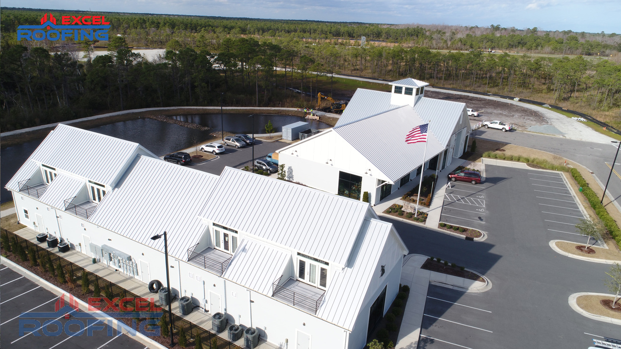 Aerial view of a metal roof installed by Excel Roofing over a shopping center in Wilmington, NC, showcasing durability and sleek design.