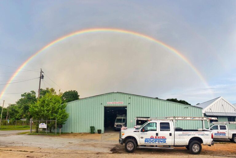 Excel Roofing Company’s Wilmington NC headquarters with branded service trucks parked out front.